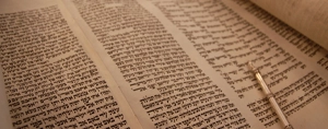 Cuộn sách Torah mở với cây chỉ tay đang trỏ vào các điều răn của Đức Chúa Trời.